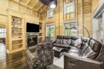 Living area has a Smart TV, seasonal gas fireplace, and large sectional sofa